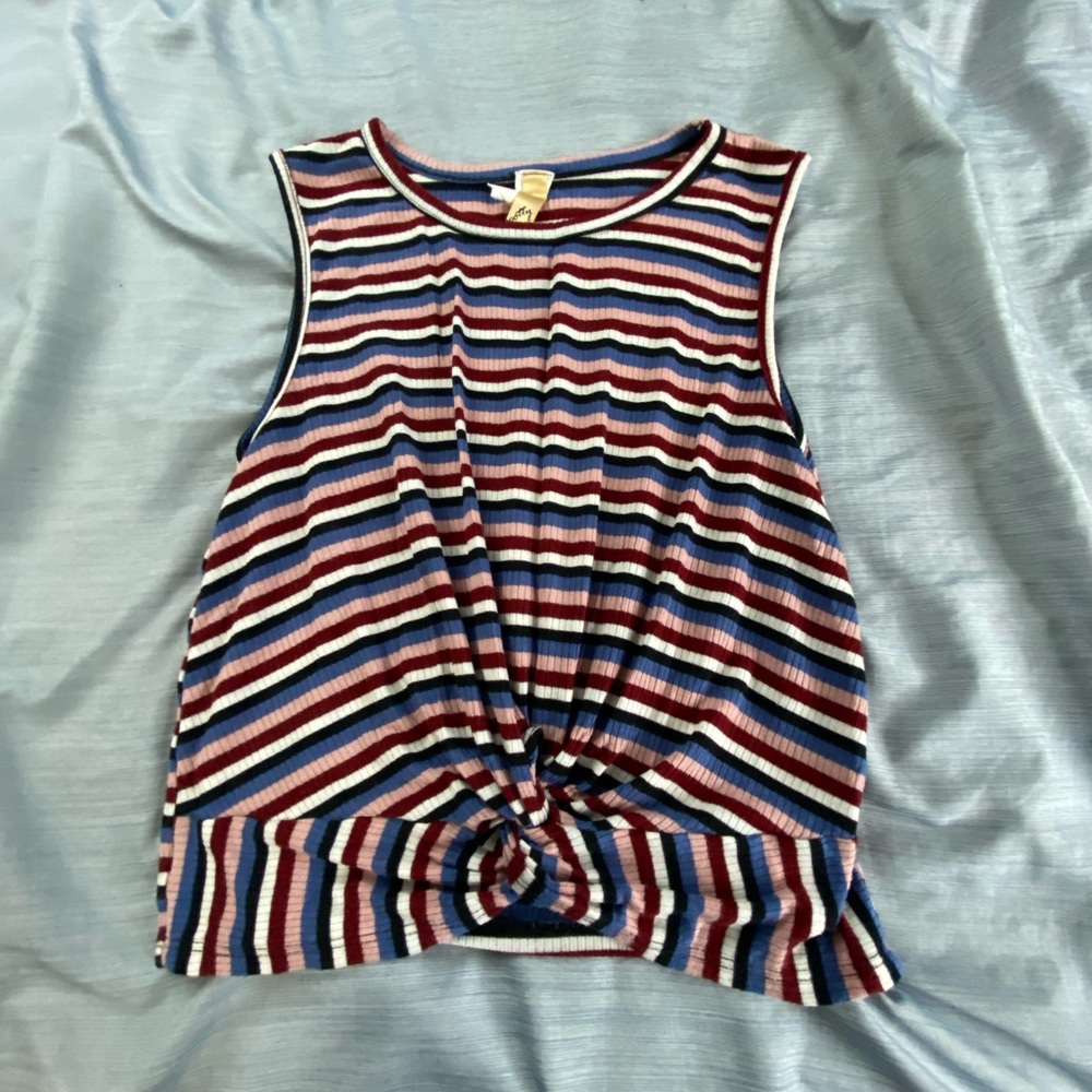 a shirt it has the colors black, white, blue, pink , red and it has stripes